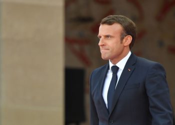 French President Emmanuel Macron walks on stage during  a French-US ceremony at the Normandy American Cemetery and Memorial in Colleville-sur-Mer, Normandy, northwestern France, on June 6, 2019, as part of D-Day commemorations marking the 75th anniversary of the World War II Allied landings in Normandy. (Photo by MANDEL NGAN / AFP)