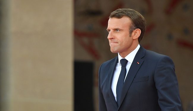 French President Emmanuel Macron walks on stage during  a French-US ceremony at the Normandy American Cemetery and Memorial in Colleville-sur-Mer, Normandy, northwestern France, on June 6, 2019, as part of D-Day commemorations marking the 75th anniversary of the World War II Allied landings in Normandy. (Photo by MANDEL NGAN / AFP)