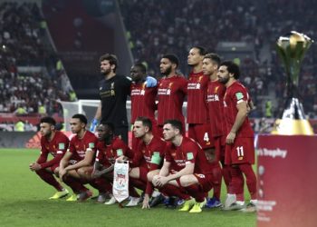 Players of Liverpool line up next to the trophy for winners of the Club World Cup final soccer match between Liverpool and Flamengo at Khalifa International Stadium in Doha, Qatar, Saturday, Dec. 21, 2019. (AP Photo/Hassan Ammar)