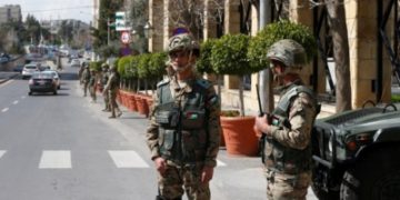 Jordanian army members stand guard outside a hotel that was transformed into a quarantine station amid concerns over the coronavirus (COVID-19) in Amman, Jordan, March 17, 2020. REUTERS/Muhammad Hamed