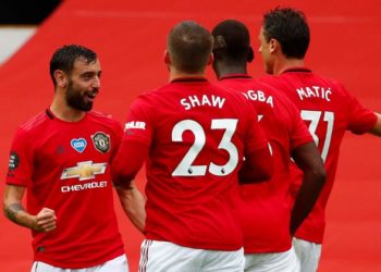 Manchester United's Portuguese midfielder Bruno Fernandes (L) celebrates with teammates after scoring a goal during the English Premier League football match between Manchester United and Bournemouth at Old Trafford in Manchester, north west England, on July 4, 2020. (Photo by Clive Brunskill / POOL / AFP) / RESTRICTED TO EDITORIAL USE. No use with unauthorized audio, video, data, fixture lists, club/league logos or 'live' services. Online in-match use limited to 120 images. An additional 40 images may be used in extra time. No video emulation. Social media in-match use limited to 120 images. An additional 40 images may be used in extra time. No use in betting publications, games or single club/league/player publications. /