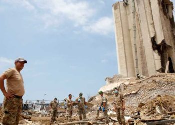 Lebanese soldiers stand at the site of the explosion in the port of Beirut, Lebanon, on August 6, 2020, two days after a massive explosion devastated the Lebanese capital in a disaster that has sparked grief and fury. - French President Emmanuel Macron visited shell-shocked Beirut on August 6, pledging support and urging change after a massive explosion devastated the Lebanese capital in a disaster that has sparked grief and fury. (Photo by Thibault Camus / POOL / AFP)