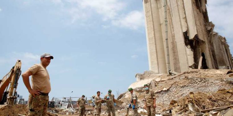 Lebanese soldiers stand at the site of the explosion in the port of Beirut, Lebanon, on August 6, 2020, two days after a massive explosion devastated the Lebanese capital in a disaster that has sparked grief and fury. - French President Emmanuel Macron visited shell-shocked Beirut on August 6, pledging support and urging change after a massive explosion devastated the Lebanese capital in a disaster that has sparked grief and fury. (Photo by Thibault Camus / POOL / AFP)