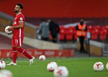 Liverpool's Egyptian midfielder Mohamed Salah takes the match ball as he walks off after the English Premier League football match between Liverpool and Leeds United at Anfield in Liverpool, north west England on September 12, 2020. - Liverpool won the game 4-3. (Photo by Shaun Botterill / POOL / AFP) / RESTRICTED TO EDITORIAL USE. No use with unauthorized audio, video, data, fixture lists, club/league logos or 'live' services. Online in-match use limited to 120 images. An additional 40 images may be used in extra time. No video emulation. Social media in-match use limited to 120 images. An additional 40 images may be used in extra time. No use in betting publications, games or single club/league/player publications. /