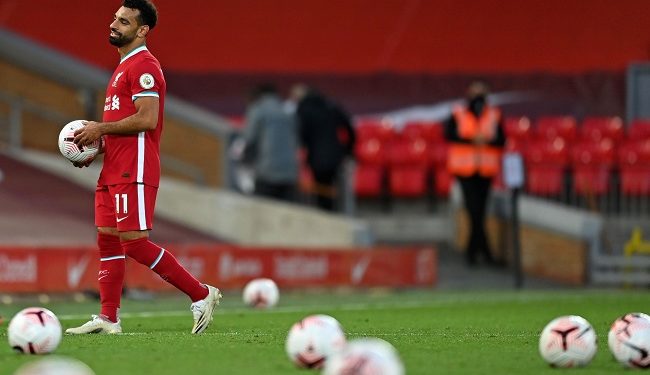 Liverpool's Egyptian midfielder Mohamed Salah takes the match ball as he walks off after the English Premier League football match between Liverpool and Leeds United at Anfield in Liverpool, north west England on September 12, 2020. - Liverpool won the game 4-3. (Photo by Shaun Botterill / POOL / AFP) / RESTRICTED TO EDITORIAL USE. No use with unauthorized audio, video, data, fixture lists, club/league logos or 'live' services. Online in-match use limited to 120 images. An additional 40 images may be used in extra time. No video emulation. Social media in-match use limited to 120 images. An additional 40 images may be used in extra time. No use in betting publications, games or single club/league/player publications. /