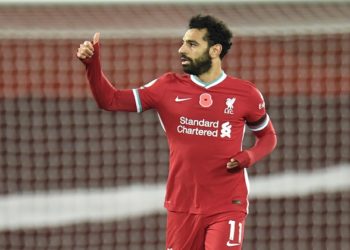 Liverpool's Mohamed Salah celebrates after he scores his sides first goal during the English Premier League soccer match between Liverpool and West Ham United at Anfield stadium in Liverpool, England, Saturday, Oct. 31, 2020. (Peter Powell/Pool via AP)