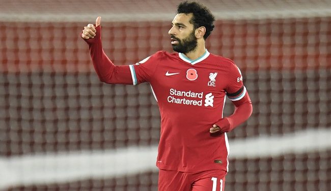 Liverpool's Mohamed Salah celebrates after he scores his sides first goal during the English Premier League soccer match between Liverpool and West Ham United at Anfield stadium in Liverpool, England, Saturday, Oct. 31, 2020. (Peter Powell/Pool via AP)