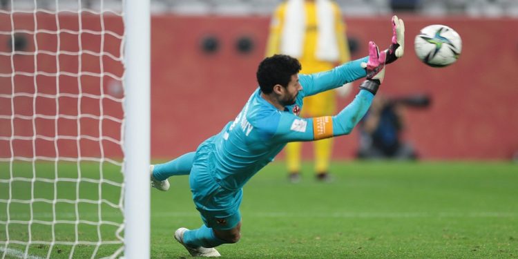 Soccer Football - Club World Cup - Third Place Play Off - Al Ahly v Palmeiras - Education City Stadium, Al Rayyan, Qatar - February 11, 2021 Al Ahly's Mohamed El-Shenawy saves the penalty from Palmeiras' Felipe Melo REUTERS/Mohammed Dabbous