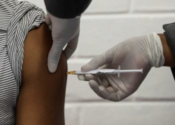 A volunteer receives an injection from a medical worker during the country's first human clinical trial for a potential vaccine against the novel coronavirus, at the Baragwanath hospital in Soweto, South Africa, June 24, 2020. REUTERS/Siphiwe Sibeko